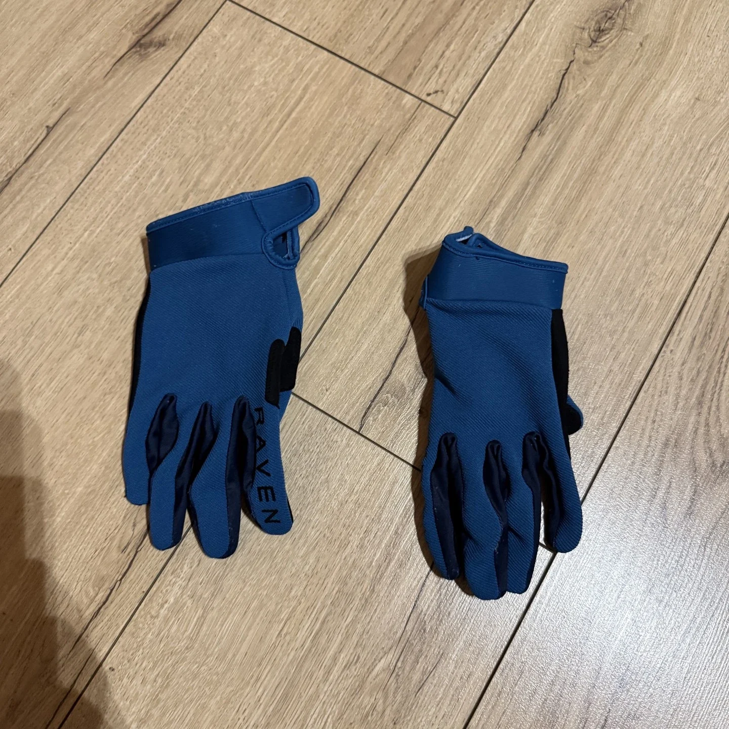 Raven MX gloves blue color laid flat showing slim fit and lightweight construction