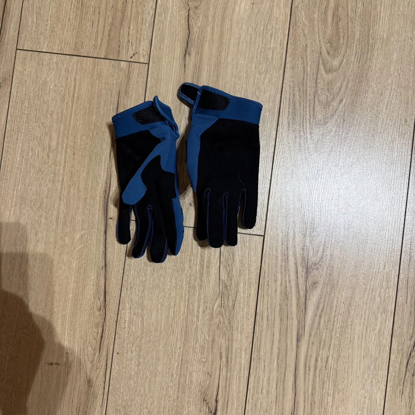 Raven MX gloves laid flat showing lightweight design and grip areas